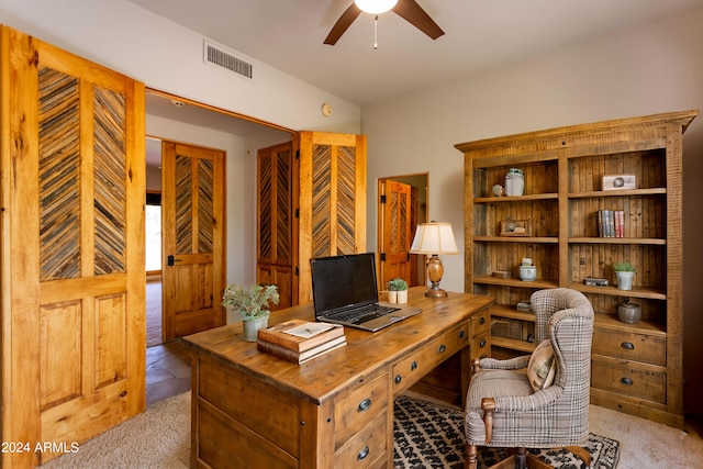 office area featuring light carpet and ceiling fan