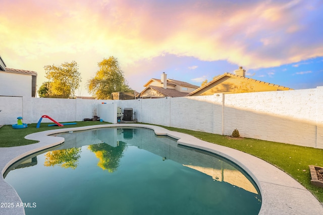 pool at dusk featuring cooling unit