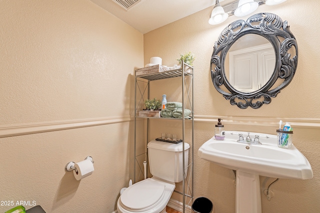 bathroom featuring toilet and lofted ceiling