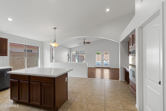 kitchen with ceiling fan, dishwasher, a kitchen island, pendant lighting, and light tile patterned floors