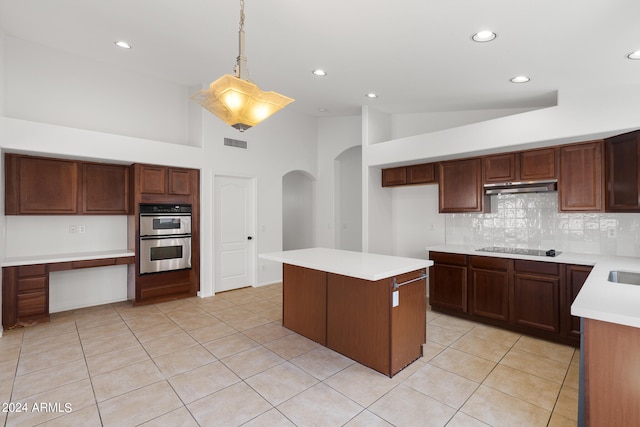 kitchen featuring stainless steel double oven, hanging light fixtures, tasteful backsplash, high vaulted ceiling, and black electric stovetop