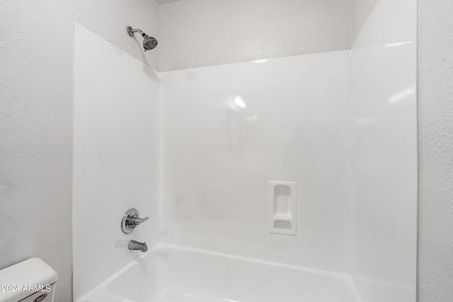 bathroom featuring toilet and shower / washtub combination