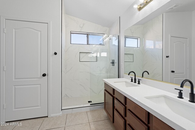 bathroom featuring tile patterned floors, vanity, and tiled shower