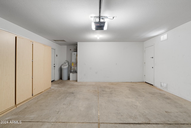 garage with gas water heater and a garage door opener