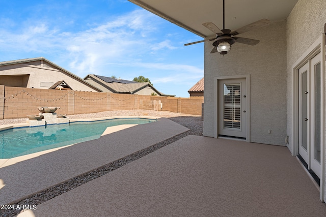 view of swimming pool with a patio and ceiling fan