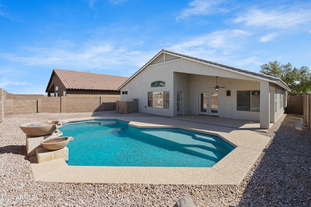 view of swimming pool featuring ceiling fan, a patio area, and french doors