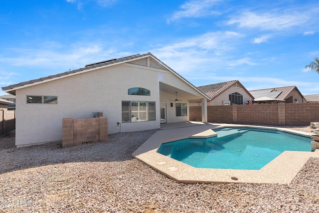 view of swimming pool featuring ceiling fan and a patio area