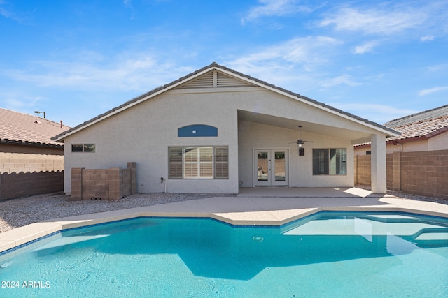 view of swimming pool featuring ceiling fan, french doors, and a patio