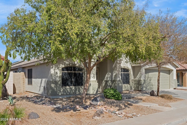 obstructed view of property with a garage