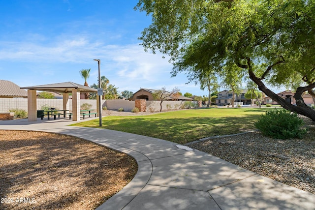 view of property's community with a gazebo and a yard