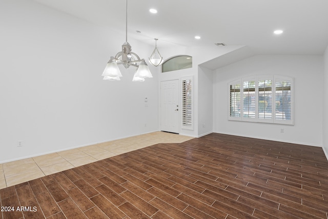 empty room with an inviting chandelier and lofted ceiling