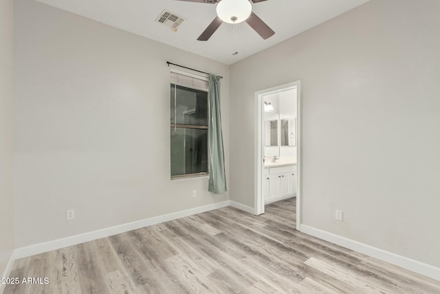 unfurnished room featuring light wood-type flooring, baseboards, visible vents, and ceiling fan