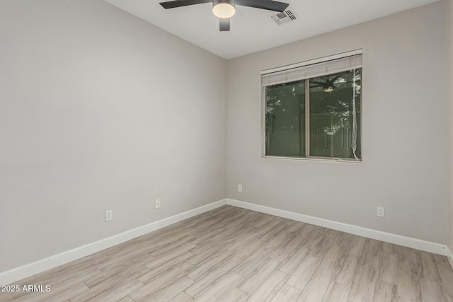 empty room featuring visible vents, wood finished floors, baseboards, and ceiling fan