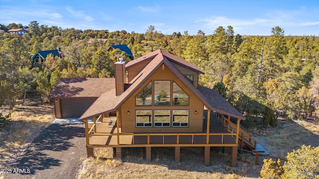 3457 E Carefree Rd, Heber, AZ 85928 - rear view of house featuring roof with shingles, a wooded view, and a chimney