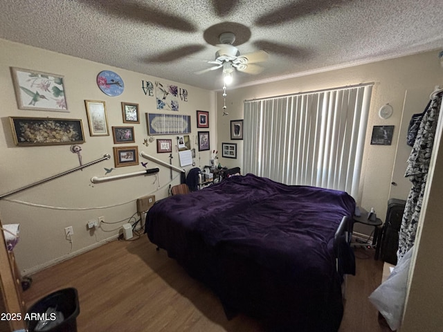 10833 N 43rd Dr, Glendale, AZ 85304 - bedroom featuring wood finished floors, a textured ceiling, and a ceiling fan