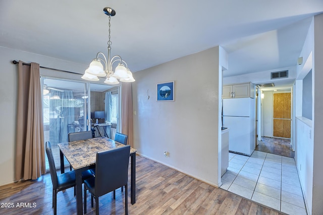 5410 E University Dr, Mesa, AZ 85205 - dining space with a chandelier and light wood-type flooring