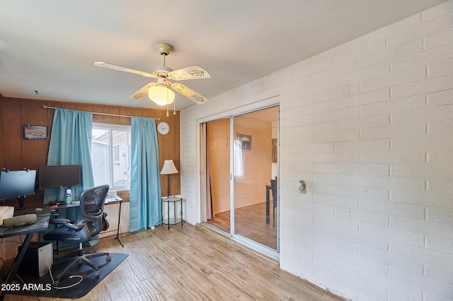 5410 E University Dr, Mesa, AZ 85205 - home office with light wood finished floors, ceiling fan, and wooden walls