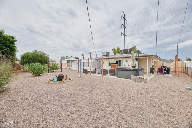 5410 E University Dr, Mesa, AZ 85205 - fenced backyard featuring outdoor lounge area, a hot tub, and a patio