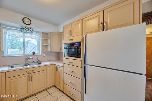 5410 E University Dr, Mesa, AZ 85205 - kitchen with freestanding refrigerator, a sink, stainless steel microwave, cream cabinetry, and light countertops