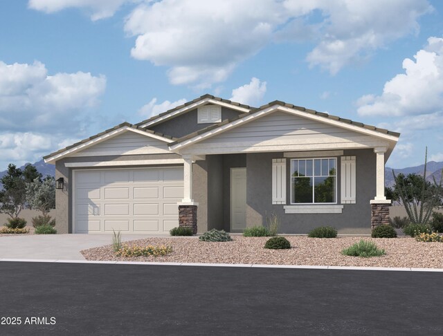 view of front of home with driveway, an attached garage, and stucco siding