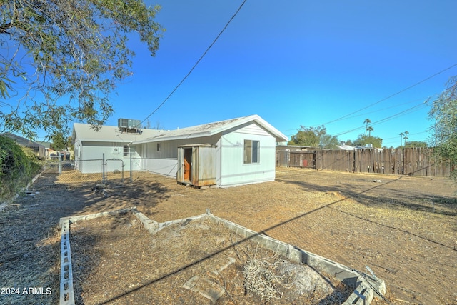 back of property featuring central air condition unit