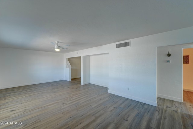 unfurnished room featuring ceiling fan and light wood-type flooring