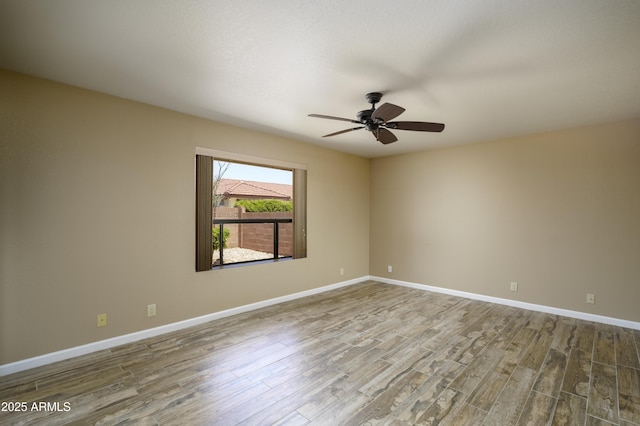 8230 E Navarro Ave, Mesa, AZ 85209 - empty room featuring wood finished floors, a ceiling fan, and baseboards