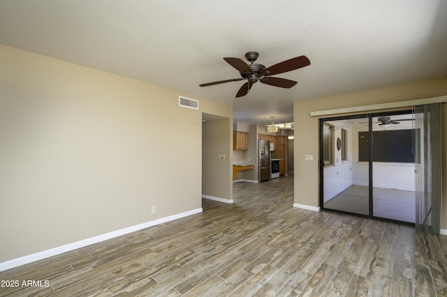 8230 E Navarro Ave, Mesa, AZ 85209 - spare room featuring ceiling fan, light wood-style floors, and baseboards