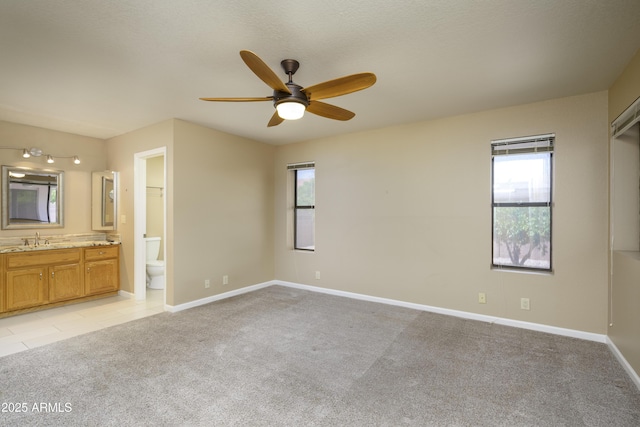 8230 E Navarro Ave, Mesa, AZ 85209 - unfurnished bedroom with light colored carpet, a sink, ensuite bath, and baseboards