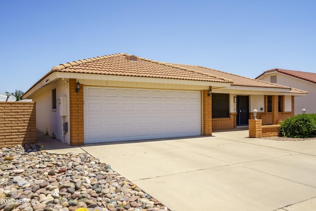 8230 E Navarro Ave, Mesa, AZ 85209 - view of front of property with an attached garage, a tile roof, concrete driveway, and brick siding