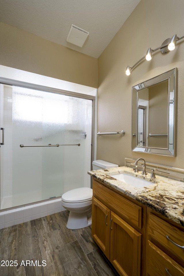 8230 E Navarro Ave, Mesa, AZ 85209 - full bath with vanity, toilet, a shower stall, and wood finished floors