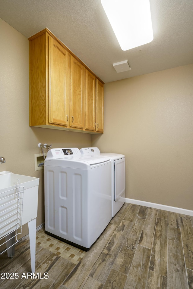 8230 E Navarro Ave, Mesa, AZ 85209 - laundry area featuring washer and clothes dryer, wood finished floors, cabinet space, and baseboards
