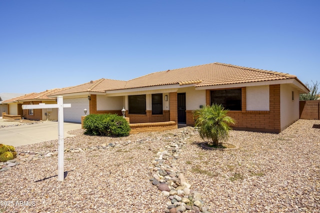8230 E Navarro Ave, Mesa, AZ 85209 - ranch-style home with a tile roof, a garage, brick siding, and driveway