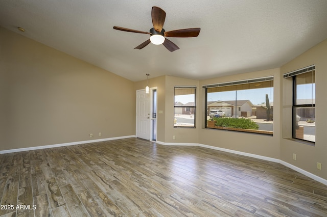 8230 E Navarro Ave, Mesa, AZ 85209 - spare room featuring ceiling fan, healthy amount of natural light, wood finished floors, and vaulted ceiling