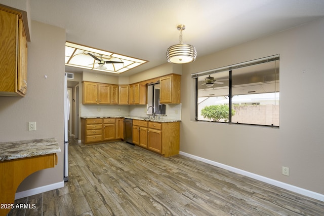 8230 E Navarro Ave, Mesa, AZ 85209 - kitchen featuring a sink, ceiling fan, wood finished floors, baseboards, and brown cabinetry