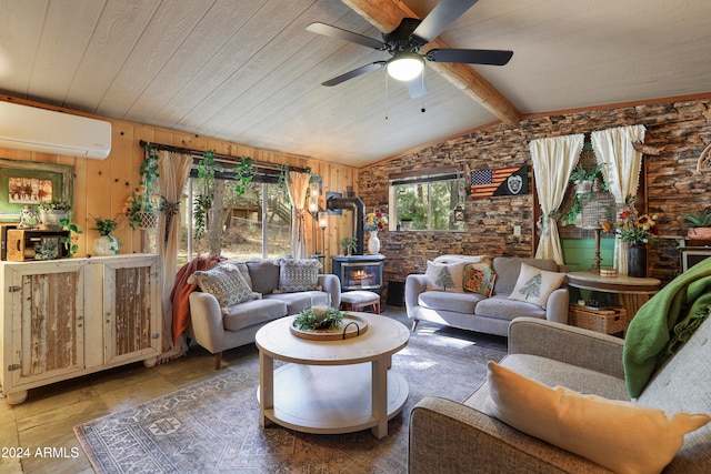 living room featuring an AC wall unit, wooden walls, a wood stove, lofted ceiling with beams, and ceiling fan