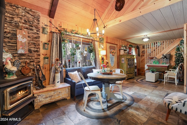 dining area with wood ceiling, beam ceiling, wooden walls, and a notable chandelier