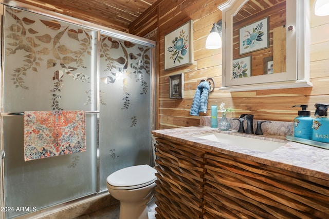 bathroom with toilet, vanity, and wooden walls