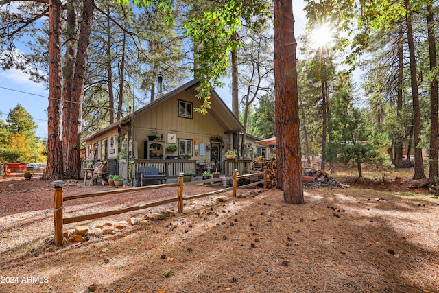 back of property featuring covered porch