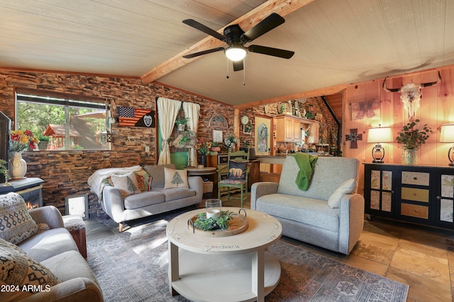 living room with wooden walls, lofted ceiling with beams, wooden ceiling, and ceiling fan