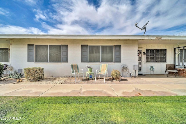 rear view of property with a patio area and a yard