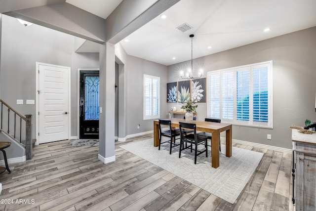 dining area featuring a chandelier and light wood-type flooring