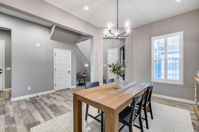 dining area with a chandelier and light hardwood / wood-style floors