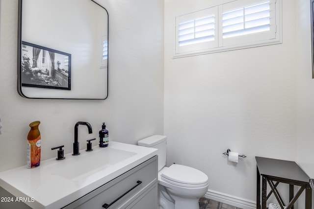 bathroom featuring toilet and vanity