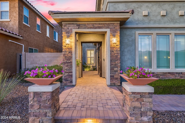 view of exterior entry at dusk