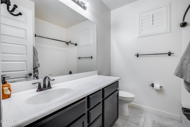 bathroom with vanity, toilet, and tile patterned floors