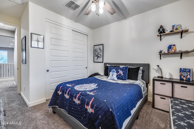 carpeted bedroom featuring a closet and ceiling fan