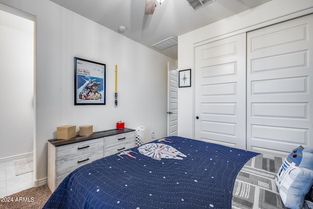 carpeted bedroom with a closet and ceiling fan