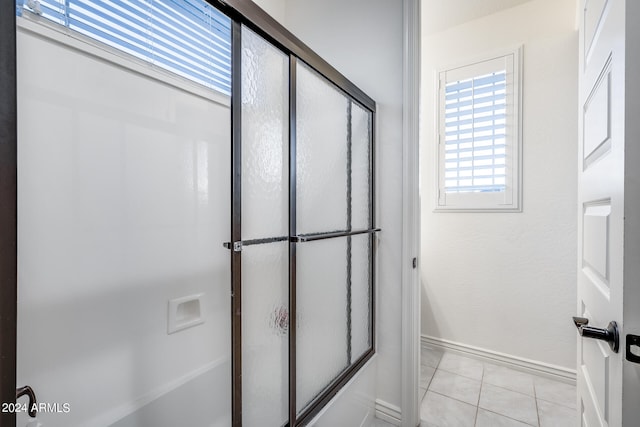 bathroom with walk in shower and tile patterned flooring