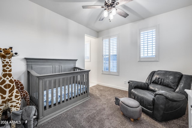 carpeted bedroom with a nursery area and ceiling fan